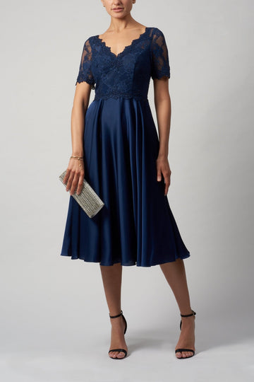 lady in navy blue cocktail dress with lace top