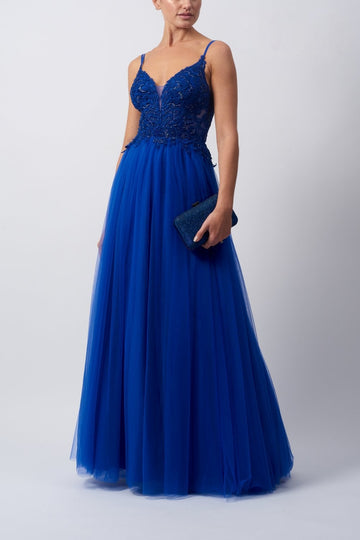 Young female standing in a Royal Blue bodice tulle prom dress